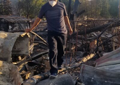 A man walking on burnt debris.