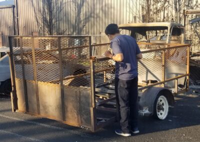 A photo of a man looking at burnt debris.