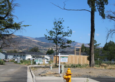 A phot of a home reconstruction project and an empty lot.